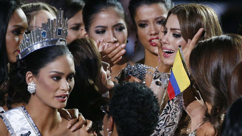 Other contestants comfort Miss Colombia Ariadna Gutierrez, top right, after she was incorrectly crowned Miss Universe at the Miss Universe pageant Sunday, Dec. 20, 2015, in Las Vegas. According to the pageant, a misreading led the announcer to read Miss Colombia Ariadna Gutierrez as the winner before they took it away and gave it to Miss Philippines Pia Alonzo Wurtzbach, pictured on left. (AP Photo/John Locher)