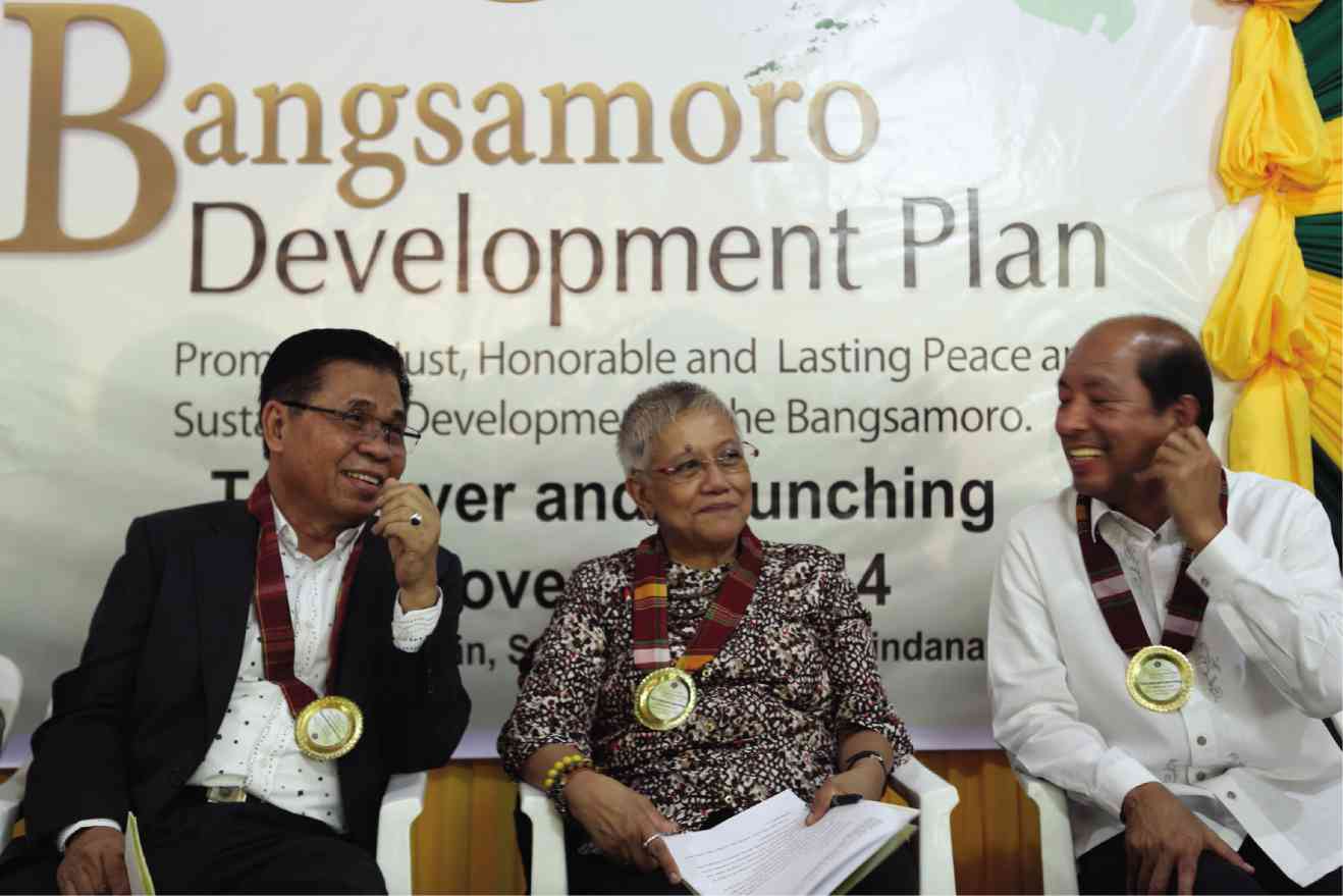 BUDGET Secretary Butch Abad (right)  with Moro Islamic Liberation Front chair  Murad Ebrahim and Secretary Teresita Deles of the Office of the Presidential Adviser on the Peace Process at the handover ceremony on Nov. 2 of the Bangsamoro Development Plan at Camp Darapanan in Sultan Kudarat, Maguindanao.  JEOFFREY MAITEM/INQUIRER MINDANAO 