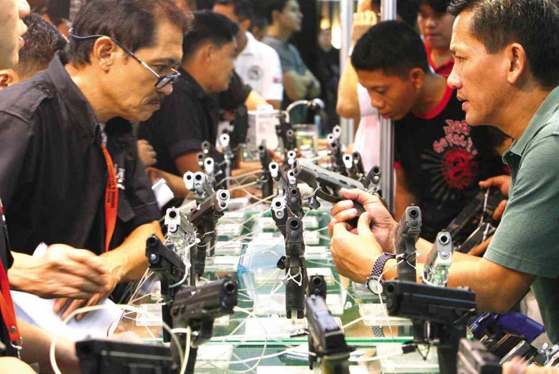 GUN SHOW   Various pistols are displayed at the Defense and Sporting Arms Show at a mall in Mandaluyong City. MARIANNE BERMUDEZ 