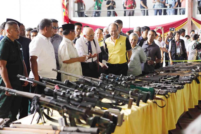DEACTIVATED President Aquino and Murad Ebrahim, Moro Islamic Liberation Front (MILF) chair, look at  the firearms decommissioned by the  group at the old provincial capitol in Sultan Kudarat town  in Maguindanao. The decommissioning of arms and combatants covered 55 high-powered and 20 crew-served weapons and 145 members of the MILF’s Bangsamoro Islamic Armed Forces.  JEOFFREY MAITEM / INQUIRER MINDANAO 
