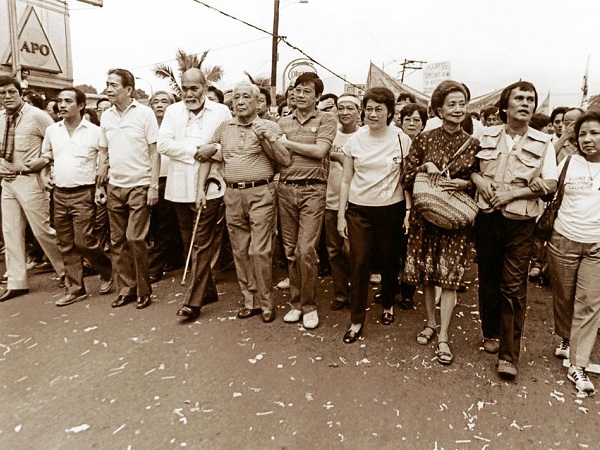 A PAGE FROM MARTIAL LAW HISTORY. The dictatorship was practically on its last legs when the usual suspects in the Marcos opposition led yet another protest march on Oct. 7, 1984. In a little over a year, People Power on Edsa would stun the world. From right: Etta Rosales, Lily de las Alas-Padilla, Cory Aquino, Wigberto Tañada, Lorenzo Tañada, Ramon Pedrosa, Ambrosio Padilla. They marched from Santo Domingo Church on Quezon Blvd Extension in Quezon City to Welcome Rotonda, on the boundary with Manila, where a reception party of riot cops dispersed them. INQUIRER PHOTO 