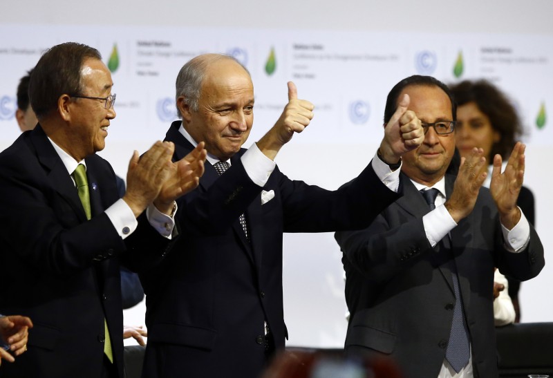 CORRECTS SPELLING OF HOLLANDE, NOT HIOLLANDE - French foreign minister and President of the COP21 Laurent Fabius, center, applauds while United Nations Secretary General Ban Ki-moon, left, and French President Francois Hollande applaud after the final conference of the COP21, the United Nations conference on climate change, in Le Bourget, north of Paris, Saturday, Dec.12, 2015. Nearly 200 nations adopted the first global pact to fight climate change on Saturday, calling on the world to collectively cut and then eliminate greenhouse gas pollution but imposing no sanctions on countries that don’t. (AP Photo/Francois Mori)