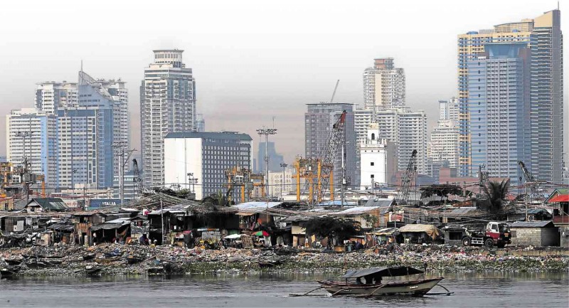 A SLUM in Baseco, Tondo in Manila, with high rises in the background         EDWIN BACASMAS