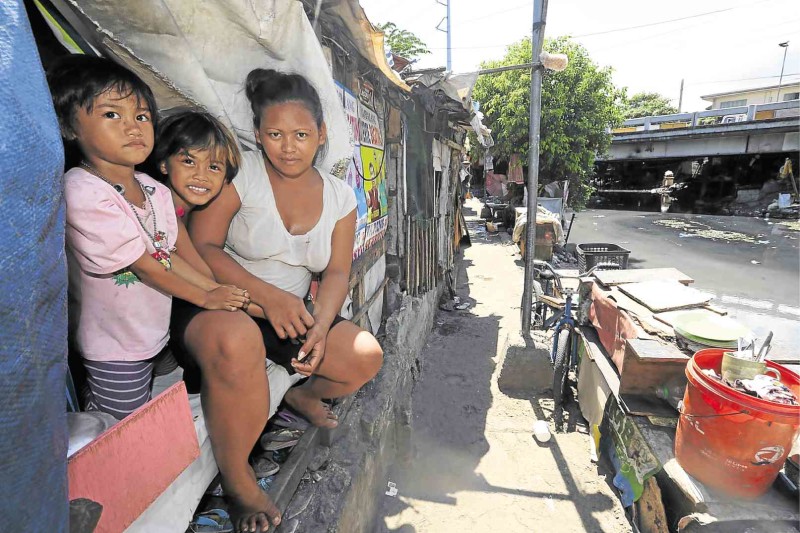 LIVING ON THE EDGE Janet Francisco, 25, with children Melody, 6, and Rose Jane, 7, living near the Paco-Pandacan Bridge in Manila. They used to live under the bridge. RAFFY LERMA---------------------Talk_Poverty