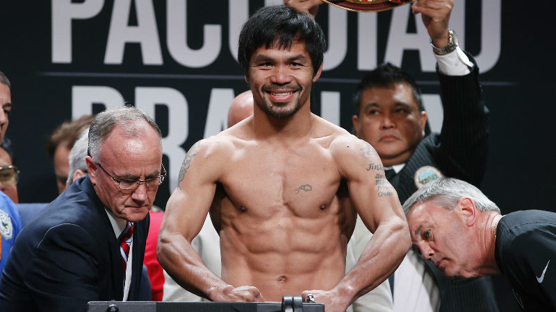 Manny Pacquiao, of the Philippines, poses on the scale during a weigh-in Friday, April 8, 2016, in Las Vegas. Pacquiao is scheduled to fight Timothy Bradley in a welterweight title fight Saturday. (AP Photo/John Locher)