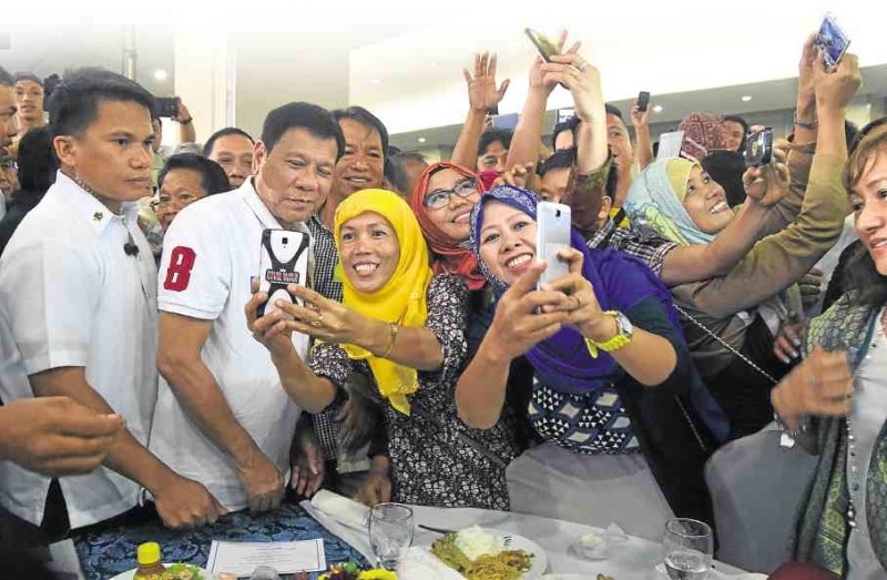 SELFIES WITH DIGONG     President Duterte gamely joins in selfies with participants of a feast celebrating the end of Ramadan in Davao City. MALACAÑANG PHOTO