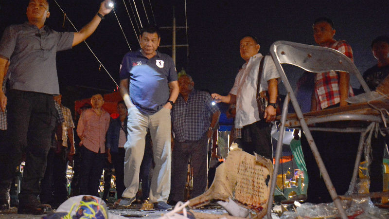 In this photo released by Malacanang Palace Presidential Communications Operations Office Presidential Photographers Division, Philippine President Rodrigo Duterte, second left, visits the site of Friday night's explosion that killed more than a dozen people and wounded several others at a night market in Davao city, his hometown, Saturday, Sept. 3, 2016 in southern Philippines. Duterte declared a nationwide "state of lawlessness" Saturday after suspected Abu Sayyaf extremists detonated a bomb at the market. (Robinson Ninal/Malacanang Palace Presidential Communications Operations Office Presidential Photographers Division via AP)