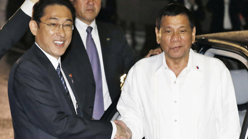 Philippine President Rodrigo Duterte, right, is greeted by Japanese Foreign Minister Fumio Kishida upon his arrival at a Japanese restaurant for dinner in Tokyo Tuesday, Oct. 25, 2016. Duterte arrived in Japan earlier in the day for a three-day visit, his first since becoming Philippine leader at the end of June. (Kazushige Fujikake/Kyodo News via AP)